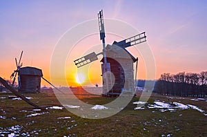 The sunset behind the windmills, Polissya Region architecture, Pyrohiv Skansen, Kyiv, Ukraine