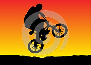 Sunset biker jumping