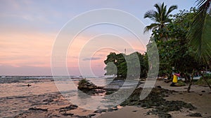 Sunset on the black sand beach of Puerto Viejo, Costa Rica