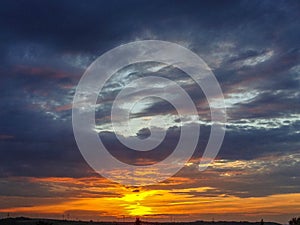 Sunset with blue and orange red glowing sky with clouds