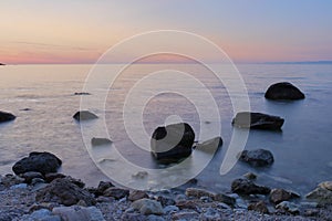 sunset with blurry sea and rocks