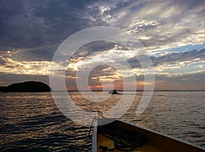 Sunset from the boat approaching Abad Santos Island in Hundreed Islands National Park, Alaminos, Philippinnes photo
