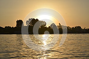 Sunset from boat in Dal lake, Srinagar, Jammu and Kashmir, India photo