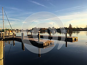 Sunset at a boat dock, reflections on the water