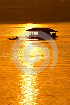 Sunset and boat with floating house