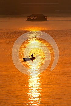 Sunset and boat with floating house