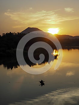 SUNSET WITH BOAT IN SUKHOTHAI