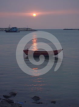 Sunset and Boats on Seashore