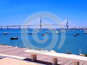 Sunset on the bridge of La Constitucion, called La Pepa, with boat sea in Cadiz, Andalusia. Spain