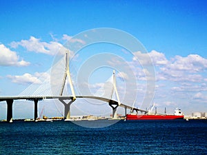 Sunset on the bridge of La Constitucion, called La Pepa, with boat sea in Cadiz, Andalusia. Spain photo