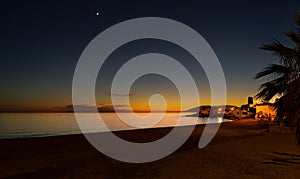 Sunset on a calm Mediterranean beach at Malaga, Spain.