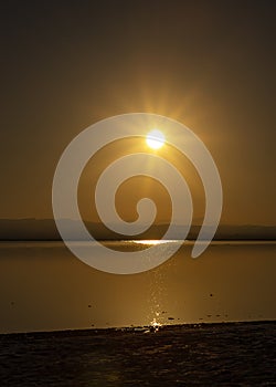 Sunset in calm water with gold reflections, twilight time. photo