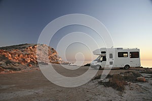 Sunset with camper at ocean shore 8