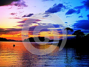 Sunset Canoe: Tranquillity and peace background at a power-full color-full sunset with canoe