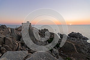 Sunset at the Capotesta Lighthouse in Sardinia photo