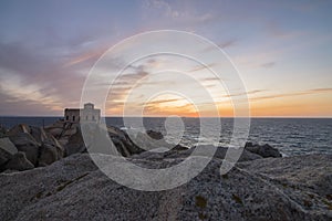 Sunset at the Capotesta lighthouse in Sardinia photo