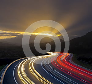 Sunset with car lights on highway