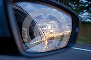 Sunset in car mirror, reflection from the nature