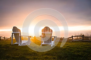 Brilliant Sunset over Fence and Chairs photo