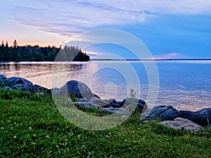 Beautiful summer sunset on the shoreline of Clear Lake, Riding Mountain National Park, Manitoba, Canada photo