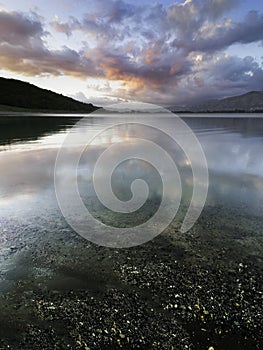 Sunset cloud reflections over a tranquil lake