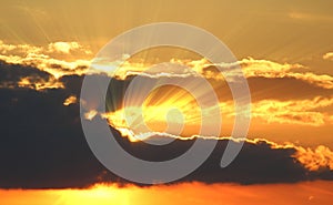 Sunset with clouds, light rays with atmospheric effect