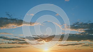 Sunset with clouds in motion. Summer sky at sunset with clouds. Timelapse.