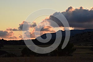 Sunset, clouds and mountains