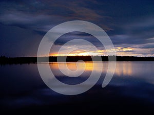 Sunset and clouds over lake. Finland,Lapland