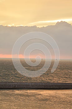 Sunset with clouds over Ocean oastell calm background