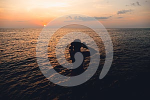 Sunset and Clouds over the Ocean,Woman watching the sun set