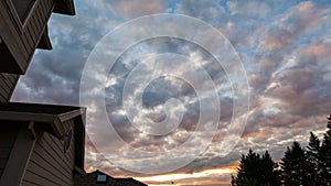 Sunset and clouds over roof of residential suburb home in Happy Valley Oregon 4k uhd