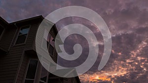 Sunset and clouds over roof of residential suburb home in Happy Valley Oregon 4k uhd