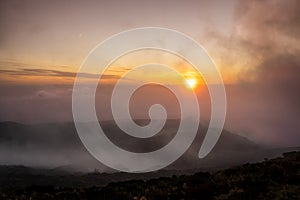 Sunset in the clouds, at Pico da Barrosa, Lagoa do Fogo area, Sao Miguel island. Azores.