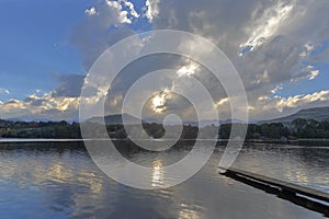 Sunset through the clouds at the pond