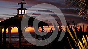 Sunset cloudscape, gazebo on beach, twilight dusk, dramatic sky. Alcove and vane