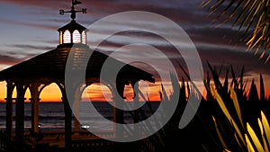 Sunset cloudscape, gazebo on beach, twilight dusk, dramatic sky. Alcove and vane