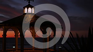 Sunset cloudscape, gazebo on beach, twilight dusk, dramatic sky. Alcove and vane