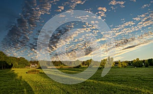 Sunset Cloudscape over Lush Field