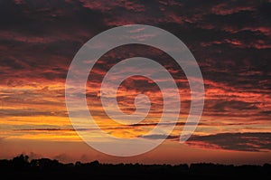 Red sunset sky, dark clouds
