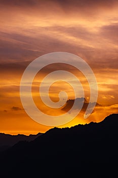 Sunset colours in sky over a mountain