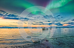 Sunset on the Cook Inlet in Alaska with the Northern Lights Appearing in the Sky over the Mountains