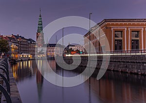 Sunset in Copenhagen on an old canal with boats and houses reflecting in the calm waters - 10