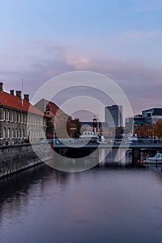 Sunset in Copenhagen on an old canal with boats and houses reflecting in the calm waters - 5