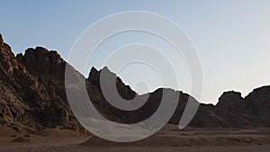 Sunset in the desert in Egypt. Mountain cliff in the desert at sunset. Nature and landscape