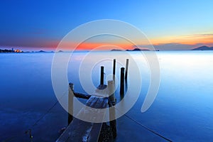 Sunset at dusk along a wooden pier