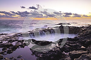 Sunset at El Bufadero natural blowhole on Gran Canaria. Ocean waves hiting rocks