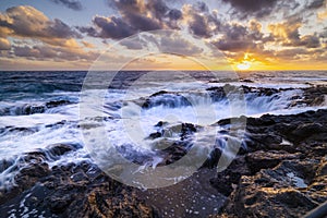 Sunset at El Bufadero natural blowhole on Gran Canaria. Ocean waves hiting rocks