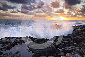 Sunset at El Bufadero natural blowhole on Gran Canaria. Ocean waves hiting rocks