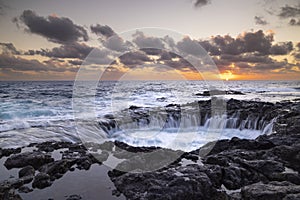 Sunset at El Bufadero natural blowhole on Gran Canaria. Ocean waves hiting rocks